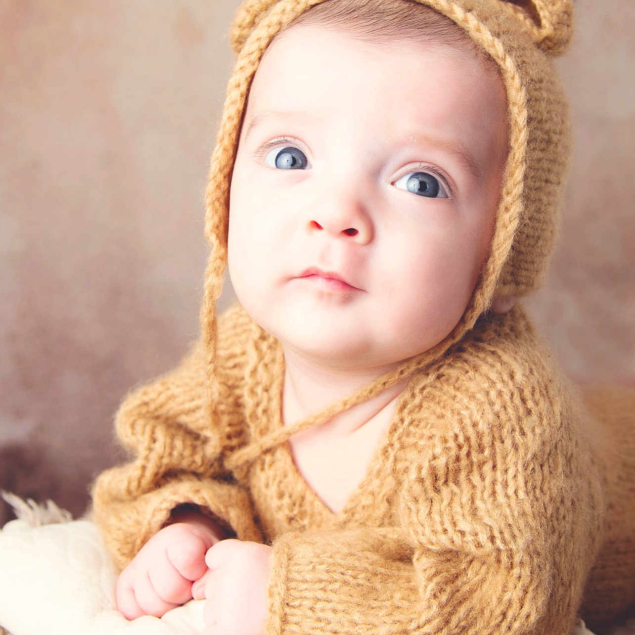 Karter is registered to the contest to win money with this photo: baby, bodypart, bonnet, cap, clothing, face, finger, hand, happy, hat, head, hood, knitwear, newborn, person, photography, portrait, sitting, smile, sweater
