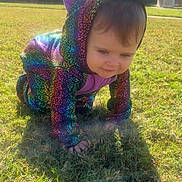 Ava joined the competition — help win amazing prizes! toddler, child, costume, rainbow, dinosaur, grass, outdoor, sunlight, crawling, baby, playful, cute, hooded, purple, colorful, smiling, person, yard, daytime, house