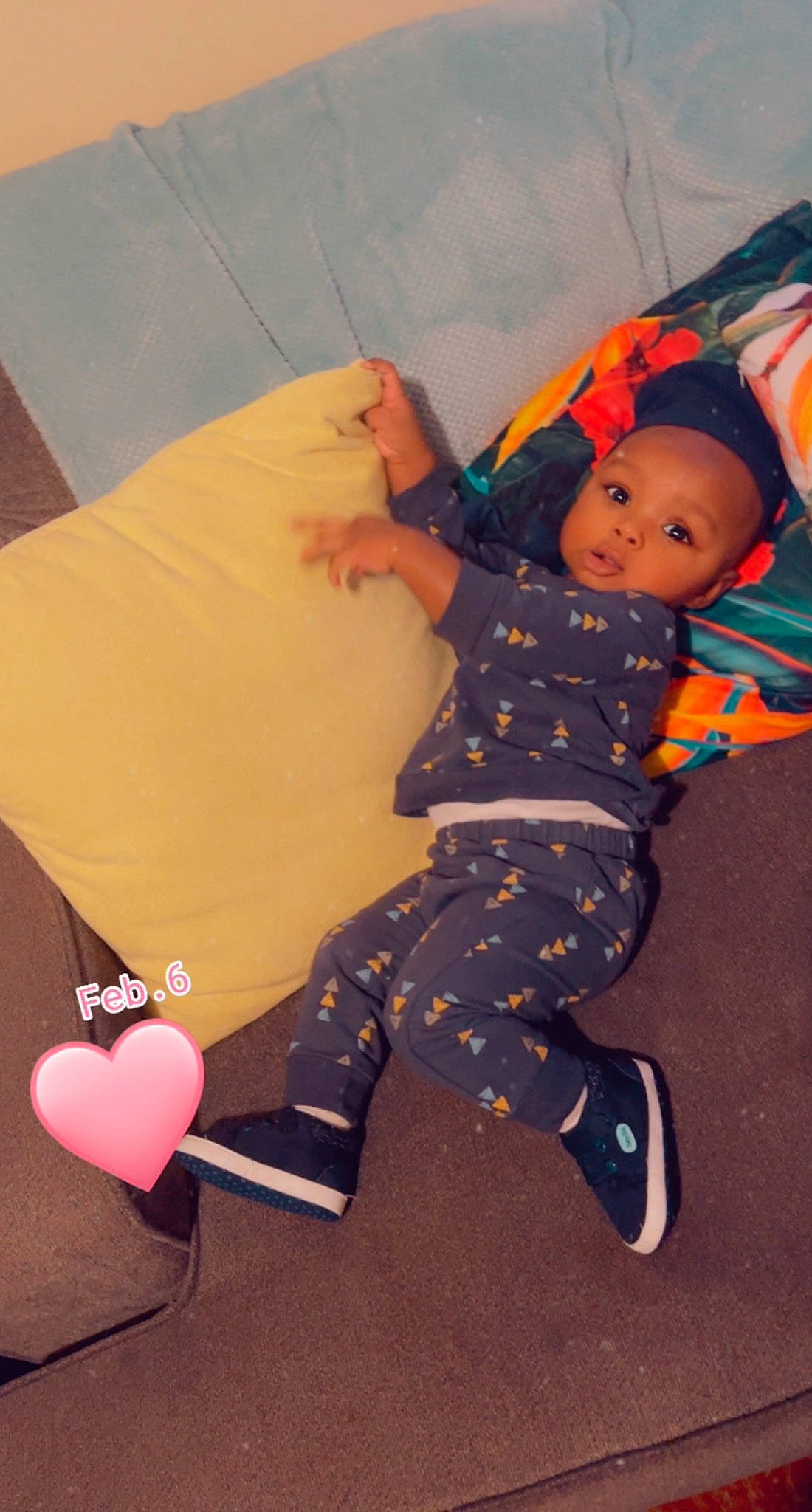 Jaivyn is registered to the contest to win money with this photo: baby, baby_toddler_clothing, boot, child, comfort, foot, fun, headwear, human_body, human_leg, knee, lap, leg, leisure, pattern, person, pink, play, sitting, sock