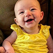 Willow is registered to the contest to win money with this photo: baby, child, infant, smiling, happy, portrait, yellow_outfit, dress, sitting, indoor, armchair, close_up, face, eyes, mouth, joy, cozy, photography, humor, family