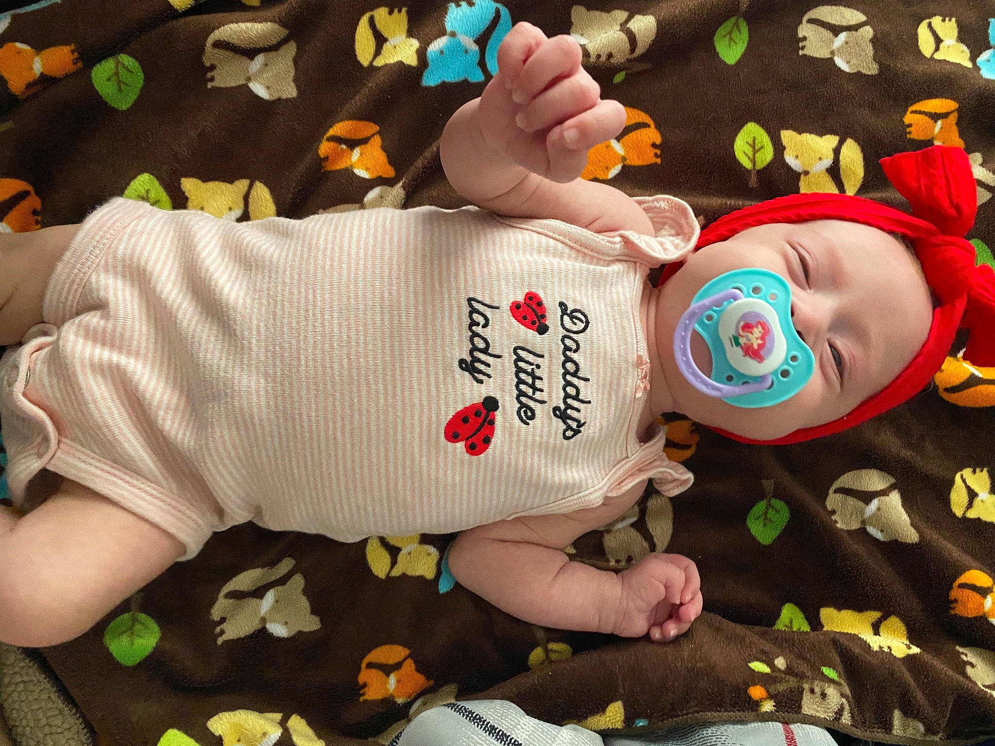 Braelynn is registered to the contest to win money with this photo: baby, baby_toddler_clothing, child, comfort, elbow, finger, foot, gesture, hand, happy, human_body, human_leg, linens, nail, person, sleeve, t_shirt, thigh, thumb, toddler