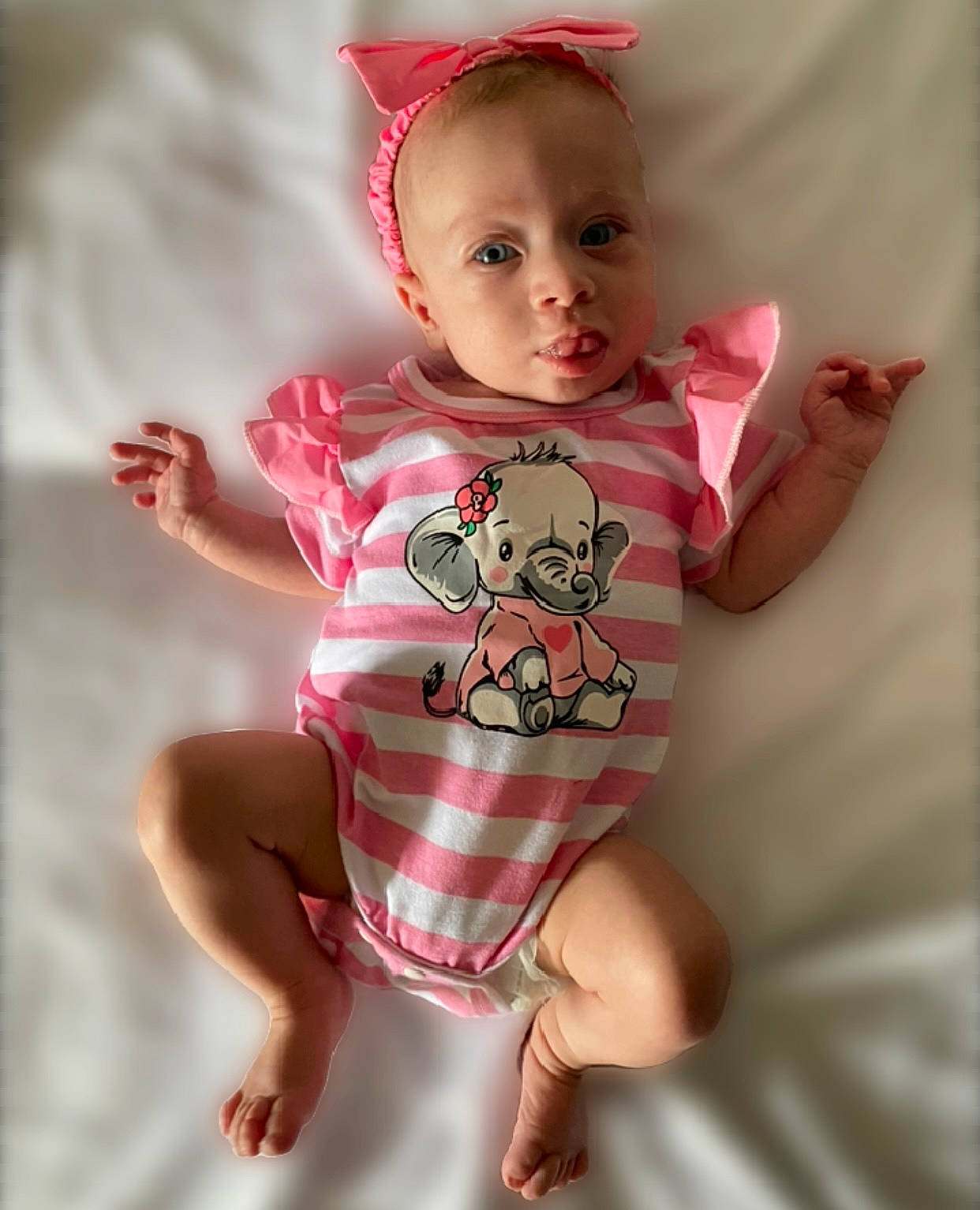 Braelynn is registered to the contest to win money with this photo: baby, baby_toddler_clothing, cheek, eye, eyelash, face, finger, gesture, happy, head, human_body, lip, magenta, neck, one_piece_garment, person, pink, skin, sleeve, thumb