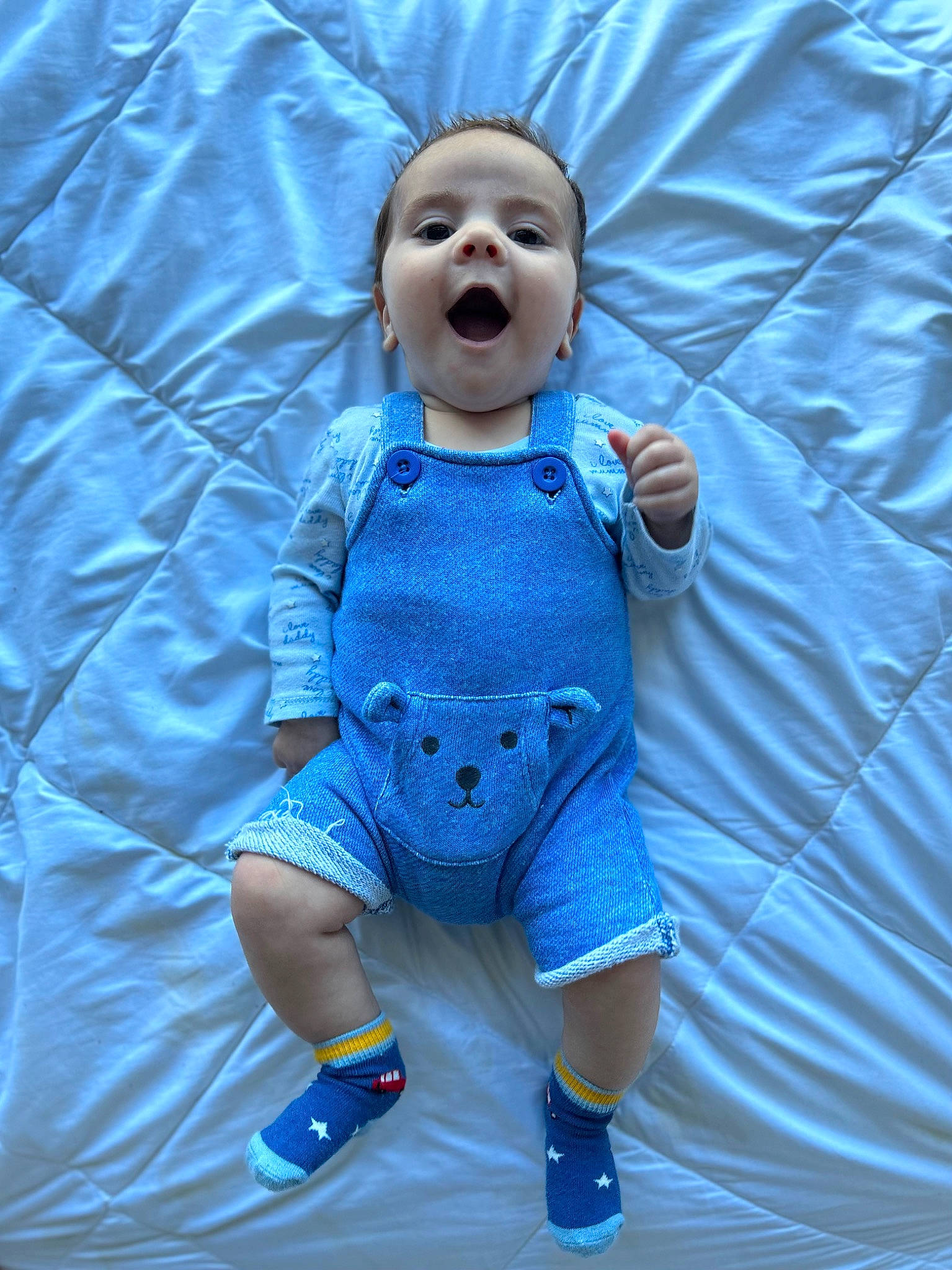 Arlo is registered to the contest to win money with this photo: arm, azure, baby, baby_products, baby_toddler_clothing, baby_toys, child, doll, electric_blue, eye, fun, hand, happy, linens, pattern, person, plastic, sleeve, t_shirt, textile