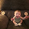 baby, armchair, smiling, happy, indoor, milestone_marker, wooden_sign, clothing, socks, child, person, furniture, seat, celebration, milestone, cute, infant, portrait, baby_girl, sitting