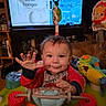 George joined the competition — help win amazing prizes! baby, child, smiling, waving, activity_center, toys, indoor, television, screen, furniture, living_room, person, happy, cute, infant, colorful, play, expression, clothing, hand