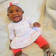 Dayana joined the competition — help win amazing prizes! baby, child, smiling, headband, heart_pattern, dress, leggings, silver_shoes, blanket, cozy, sitting, cute, happy, indoors, infant, person, portrait, apparel, footwear, fashion
