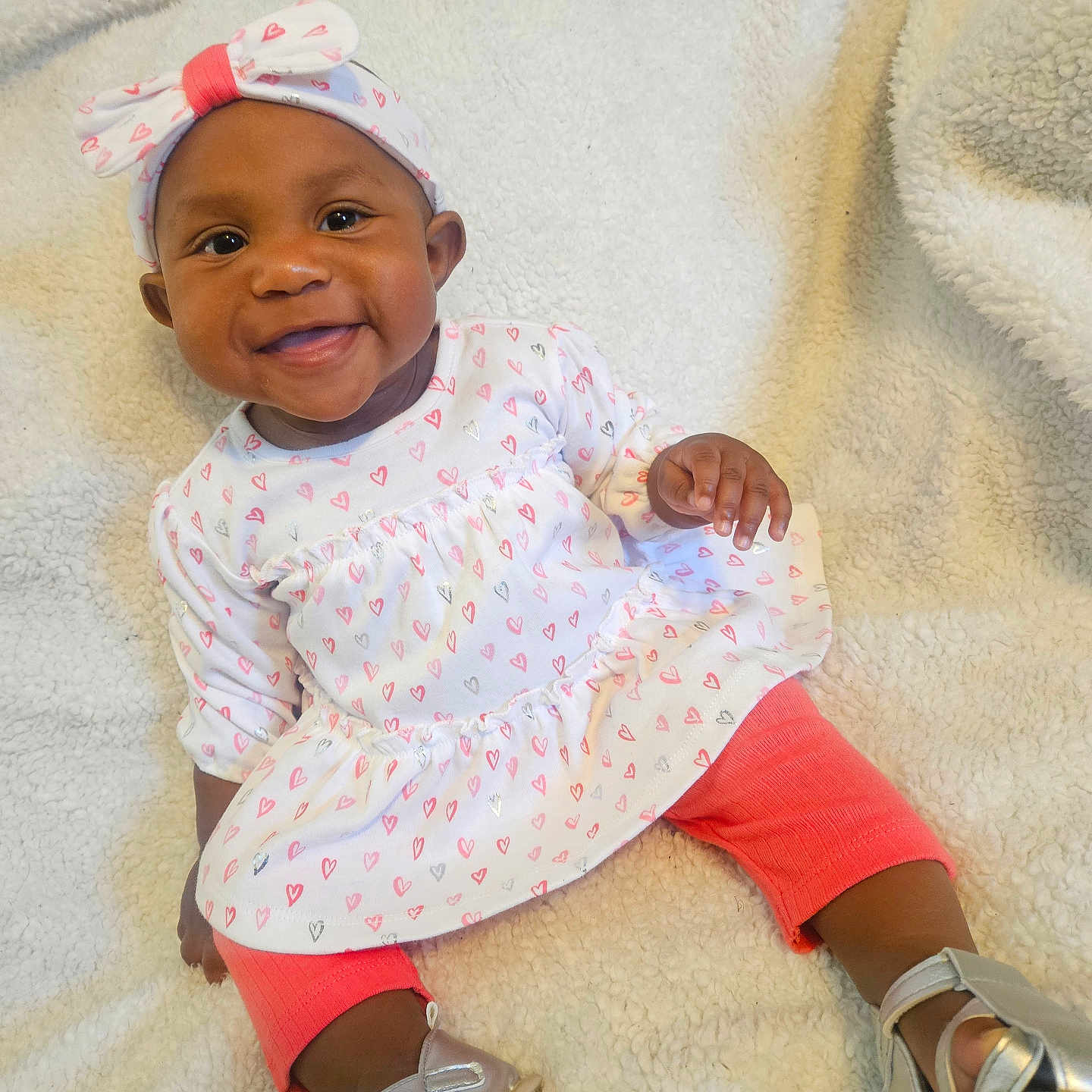 Dayana joined the competition — help win amazing prizes! apparel, baby, blanket, child, cozy, cute, dress, fashion, footwear, happy, headband, heart_pattern, indoors, infant, leggings, person, portrait, silver_shoes, sitting, smiling