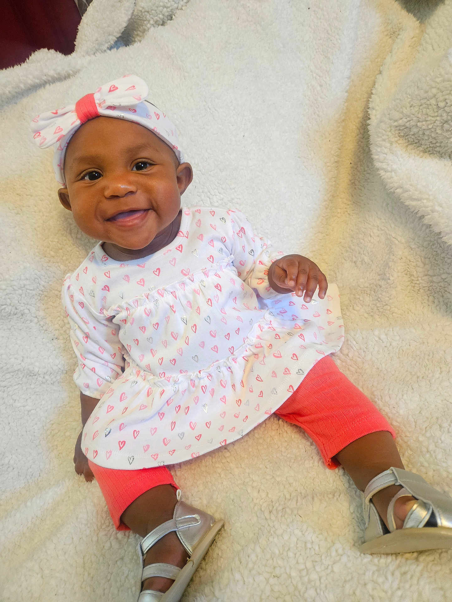 Dayana joined the competition — help win amazing prizes! baby, child, smiling, headband, heart_pattern, dress, leggings, silver_shoes, blanket, cozy, sitting, cute, happy, indoors, infant, person, portrait, apparel, footwear, fashion