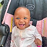 baby, child, smile, happy, car_seat, onesie, pink, white, infant, cute, face, person, seatbelt, clothing, indoor, portrait, young_child, joyful, sitting, expression