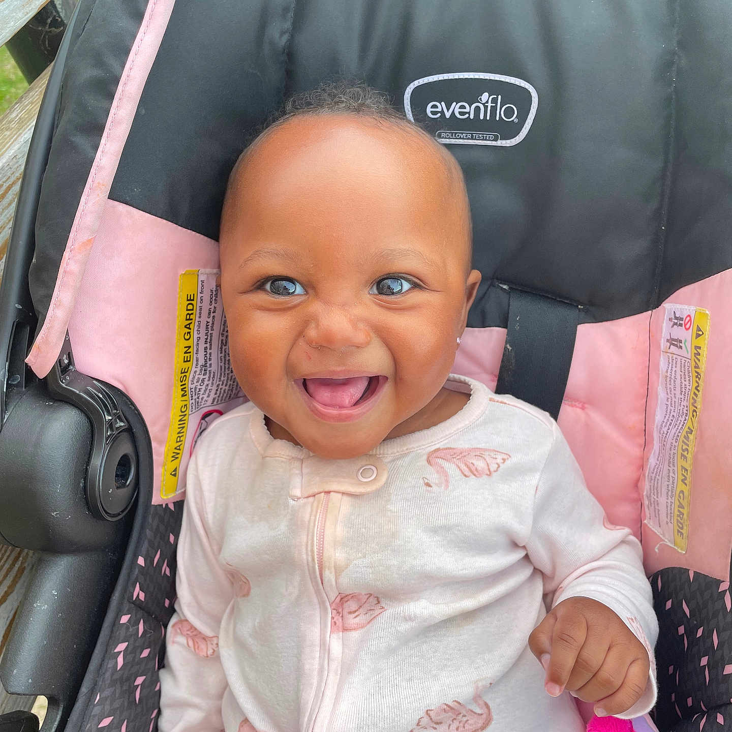 Honesty joined the competition — help win amazing prizes! baby, child, smile, happy, car_seat, onesie, pink, white, infant, cute, face, person, seatbelt, clothing, indoor, portrait, young_child, joyful, sitting, expression