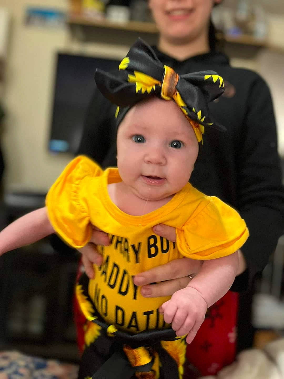 Dawn is registered to the contest to win money with this photo: baby, baby_products, baby_toddler_clothing, chair, child, costume, event, fashion_accessory, fictional_character, fun, hairstyle, happy, headwear, person, personal_protective_equipment, sitting, sleeve, smile, t_shirt, toddler