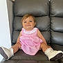 Kaylah is registered to the contest to win money with this photo: baby, child, clothing, couch, cute, footwear, furniture, gray_leather, happy, indoor, innocent, person, pink_dress, portrait, sitting, small_child, smile, toddler, white_shoes, young_child