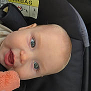 Thomas is registered to the contest to win money with this photo: baby, child, car_seat, face, blue_eyes, plush_toy, infant, safety, car_interior, head, cute, young_child, seatbelt, car, child_safety, infant_toy, portrait, close_up, expression, seat