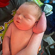 Gary is registered to the contest to win money with this photo: baby, newborn, sleeping, arm, hand, person, skin, infant, closeup, resting, peaceful, indoors, human, child, portrait, soft_light, tired, cute, holding, young