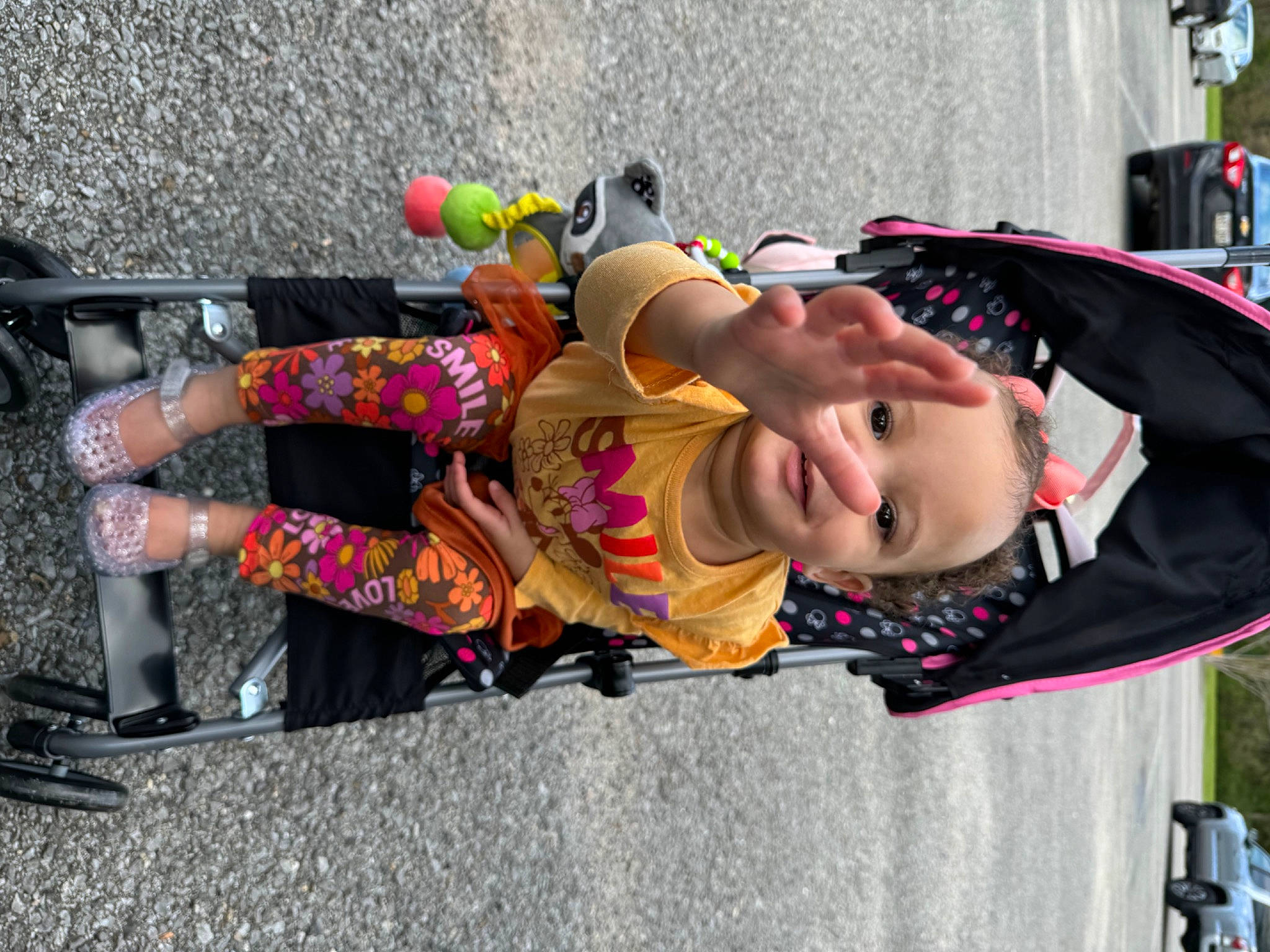 Maliyah joined the competition — help win amazing prizes! asphalt, child, event, eyewear, festival, fun, human_leg, leisure, person, pink, public_event, recreation, road, sidewalk, smile, street, sunglasses, tire, toddler, tree