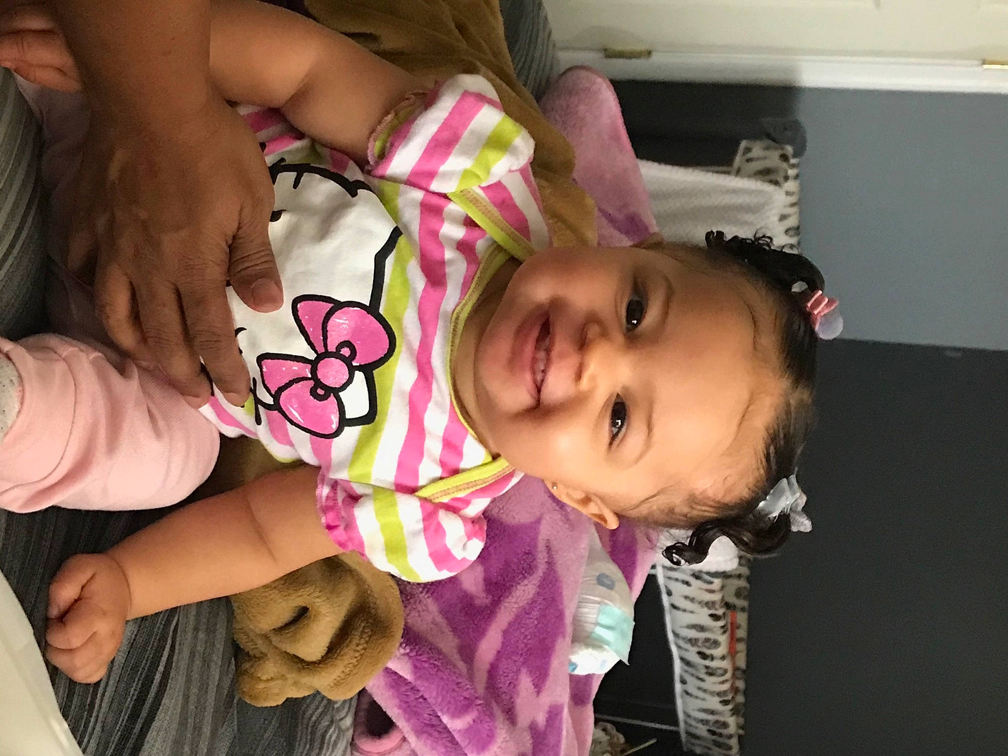Maci is registered to the contest to win money with this photo: baby, baby_toddler_clothing, cheek, dress, eyelash, facial_expression, finger, gesture, hand, happy, joy, lip, mouth, neck, nose, person, pink, skin, sleeve, smile