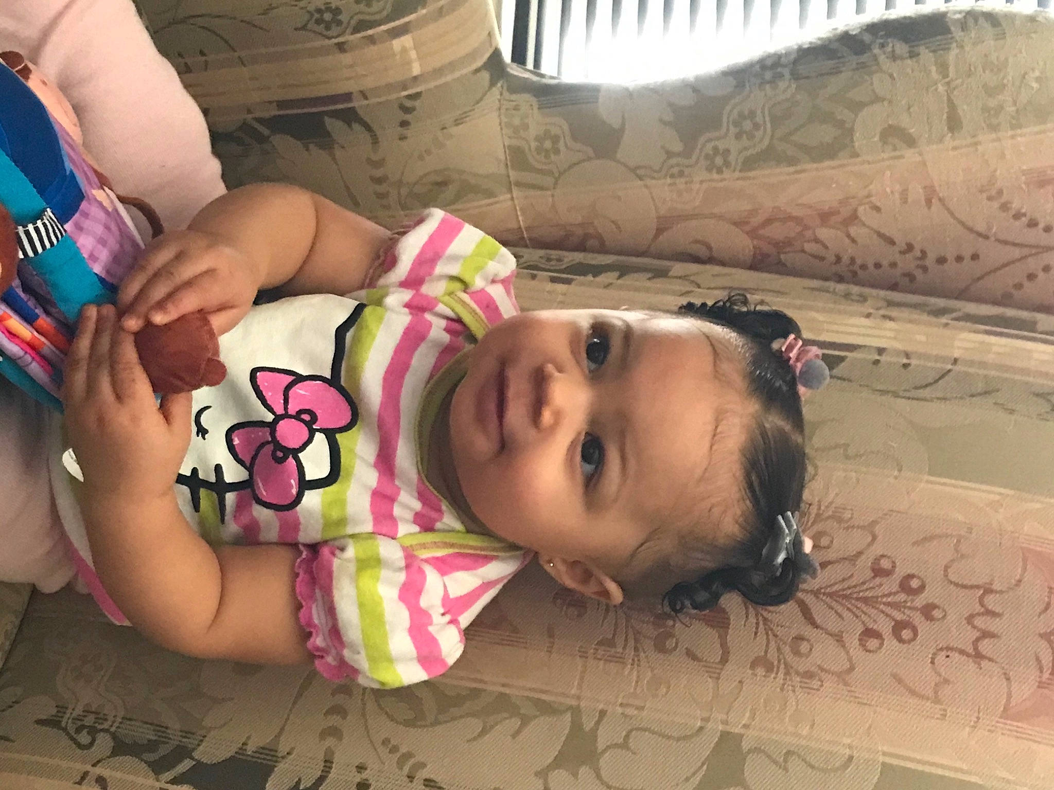 Maci is registered to the contest to win money with this photo: baby, baby_toddler_clothing, cheek, chest, child, eyelash, flooring, happy, lip, mouth, nose, organ, pattern, person, pink, skin, smile, textile, thigh, toddler