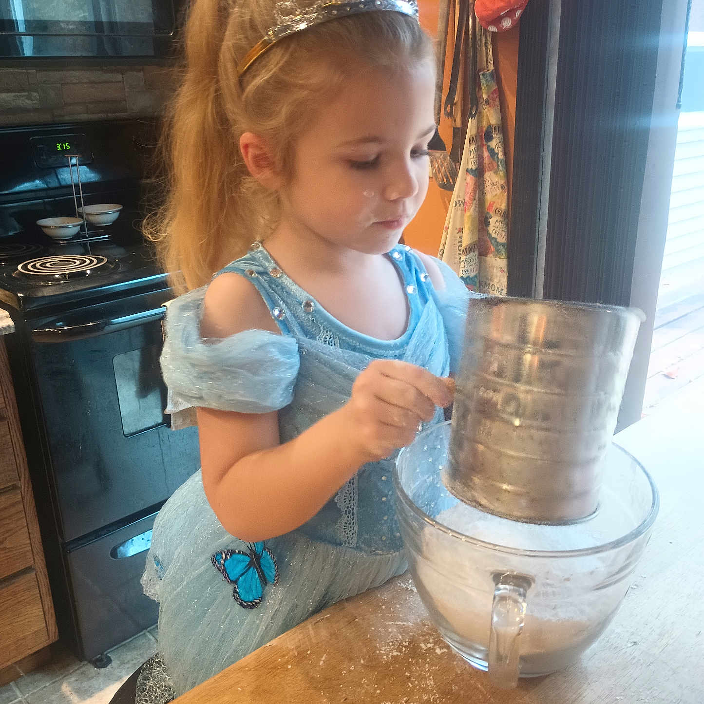 Annebell is registered to the contest to win money with this photo: accessories, bag, bowl, child, cooktop, cup, desk, device, electricaldevice, face, female, furniture, girl, handbag, head, indoors, kitchen, person, table, wood