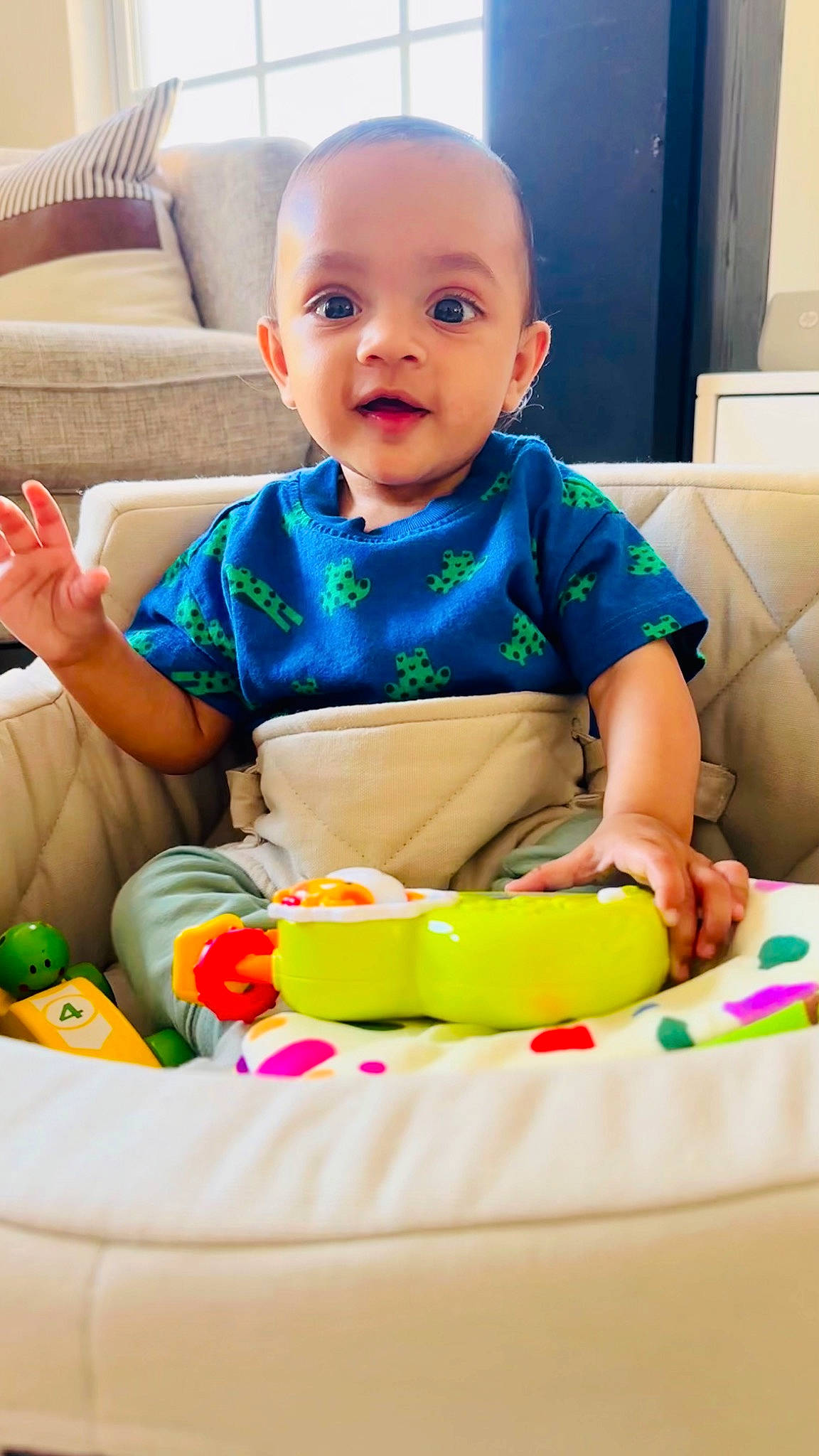 Indie is registered to the contest to win money with this photo: baby, baby_playing_with_toys, baby_products, baby_toddler_clothing, cheek, child, comfort, face, facial_expression, fun, happy, head, person, play, sitting, skin, sleeve, smile, snapshot, toddler