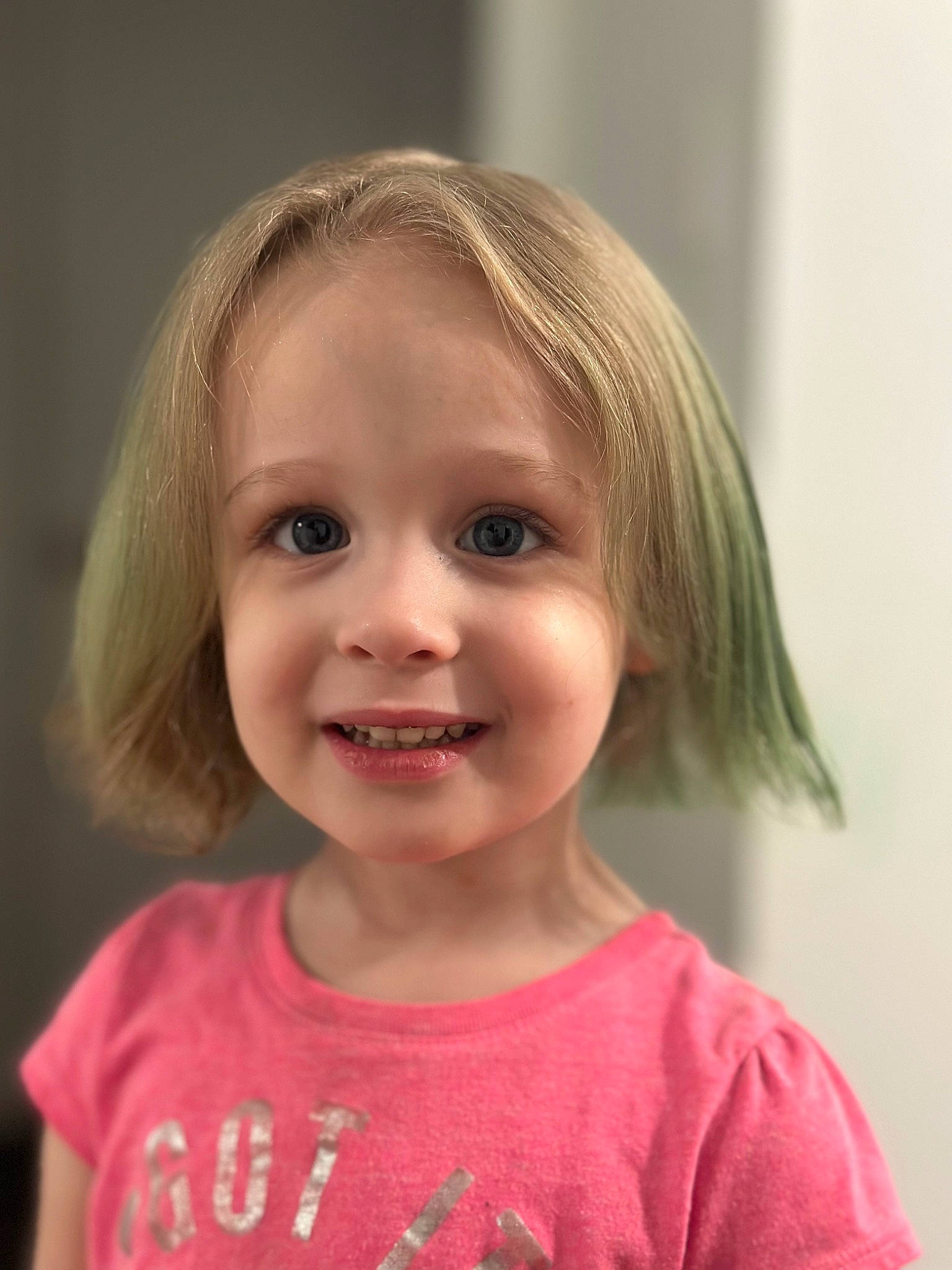 Alice is registered to the contest to win money with this photo: baby_toddler_clothing, bangs, blond, cheek, child, chin, eyebrow, eyelash, face, happy, iris, joy, lip, nose, person, pink, skin, sleeve, smile, t_shirt