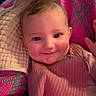 Ivy joined the competition — help win amazing prizes! baby, child, smile, face, pink_clothing, knitted_blanket, cozy, cheeks, portrait, indoors, person, warmth, texture, wool, hand, head, young_child, infant, cute, happy