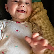 Ivy joined the competition — help win amazing prizes! baby, child, smiling, onesie, hand, blanket, texture, face, infant, cute, person, closeup, happy, skin, indoor, expression, young, portrait, reaching, lying