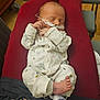 Elijah is registered to the contest to win money with this photo: newborn, baby, sleeping, pajamas, medical_tube, red_cushion, foot, toe, infant, hospital, sleep, cute, indoors, person, clothing, rest, child, bed, healthcare, comfort