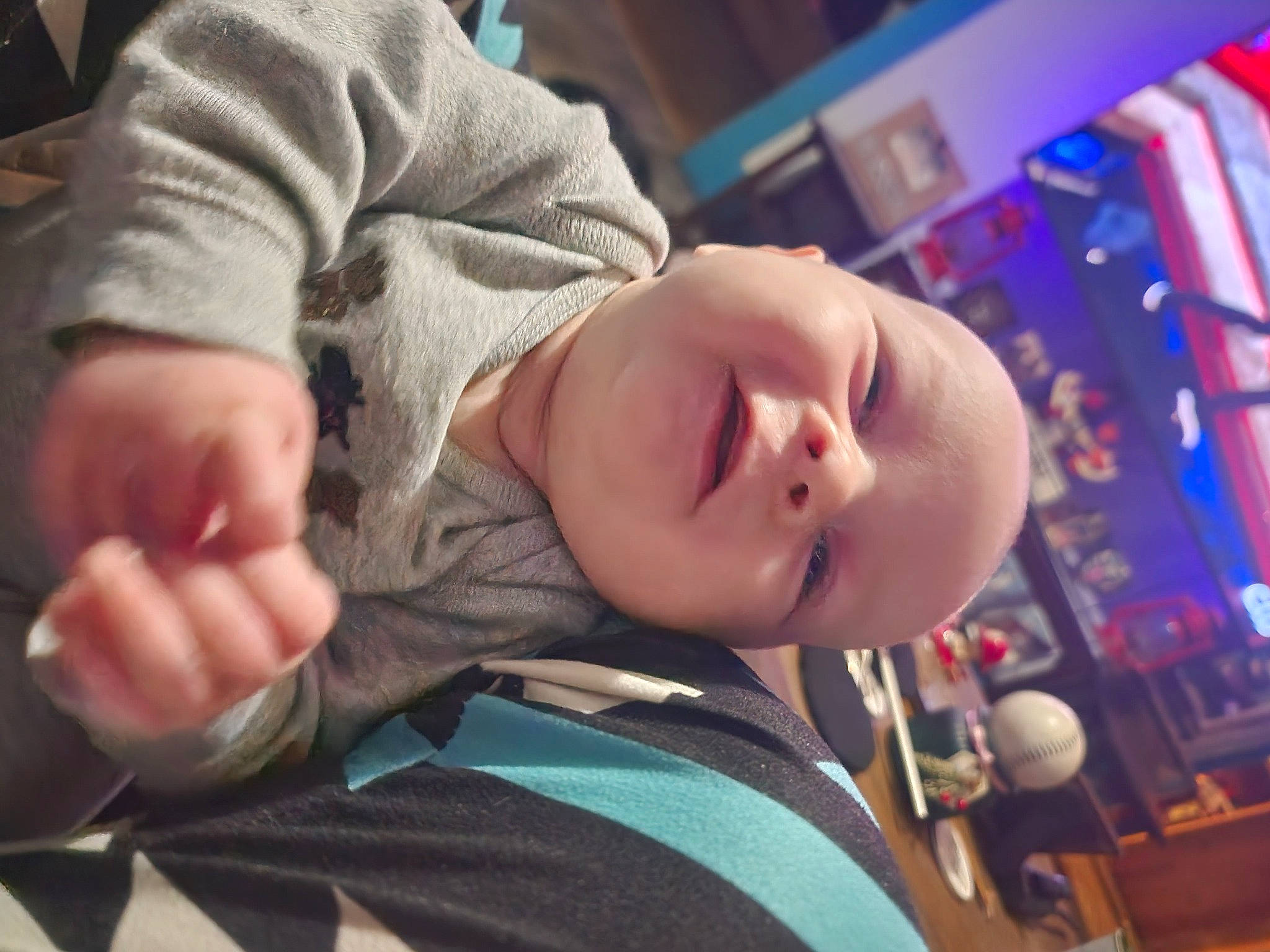 Braiden is registered to the contest to win money with this photo: audio_equipment, baby, baby_products, baby_toddler_clothing, cheek, child, comfort, finger, fun, gesture, happy, head, mouth, nose, person, room, sitting, skin, smile, toddler