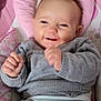 baby, infant, smiling, pink_cushion, gray_sweater, onesie, happy, cute, child, indoor, portrait, sitting, plush, soft, cuddly, person, young, skin, face, hands