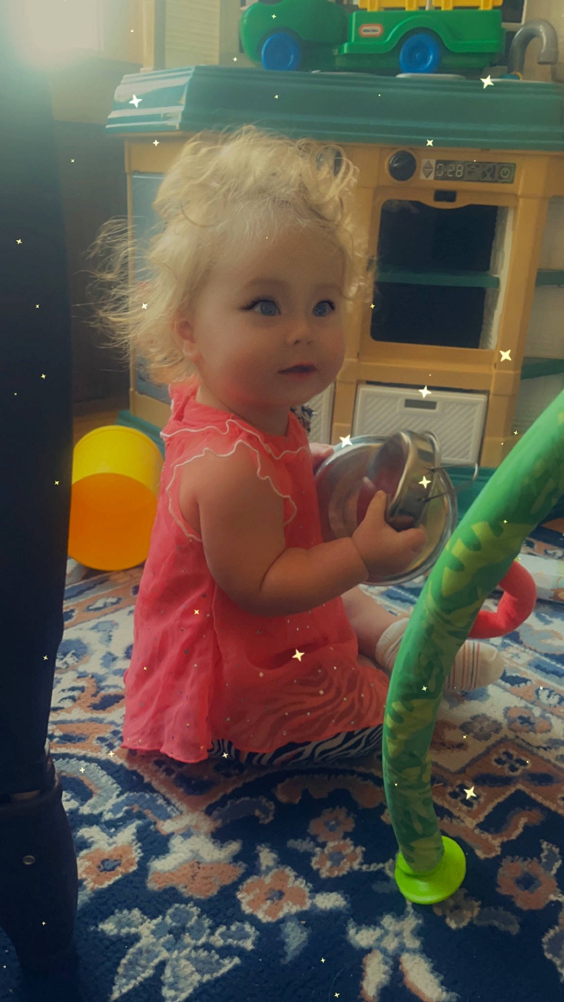 Ella is registered to the contest to win money with this photo: baby, baby_toys, child, flooring, fun, happy, human_body, person, plastic, play, product, room, sitting, smile, standing, toddler, toy, vacation