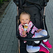 Otillia joined the competition — help win amazing prizes! baby, city, clothing, coat, cream, cutlery, dessert, eating, face, food, head, icecream, jacket, person, photography, portrait, road, street, stroller, urban