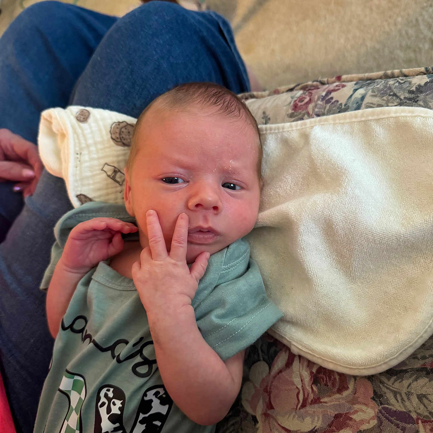 Justin is registered to the contest to win money with this photo: baby, blanket, casual, clothing, comfort, cushion, expression, fabric, face, hand, head, human, indoor, infant, lap, newborn, onesie, person, resting, skin