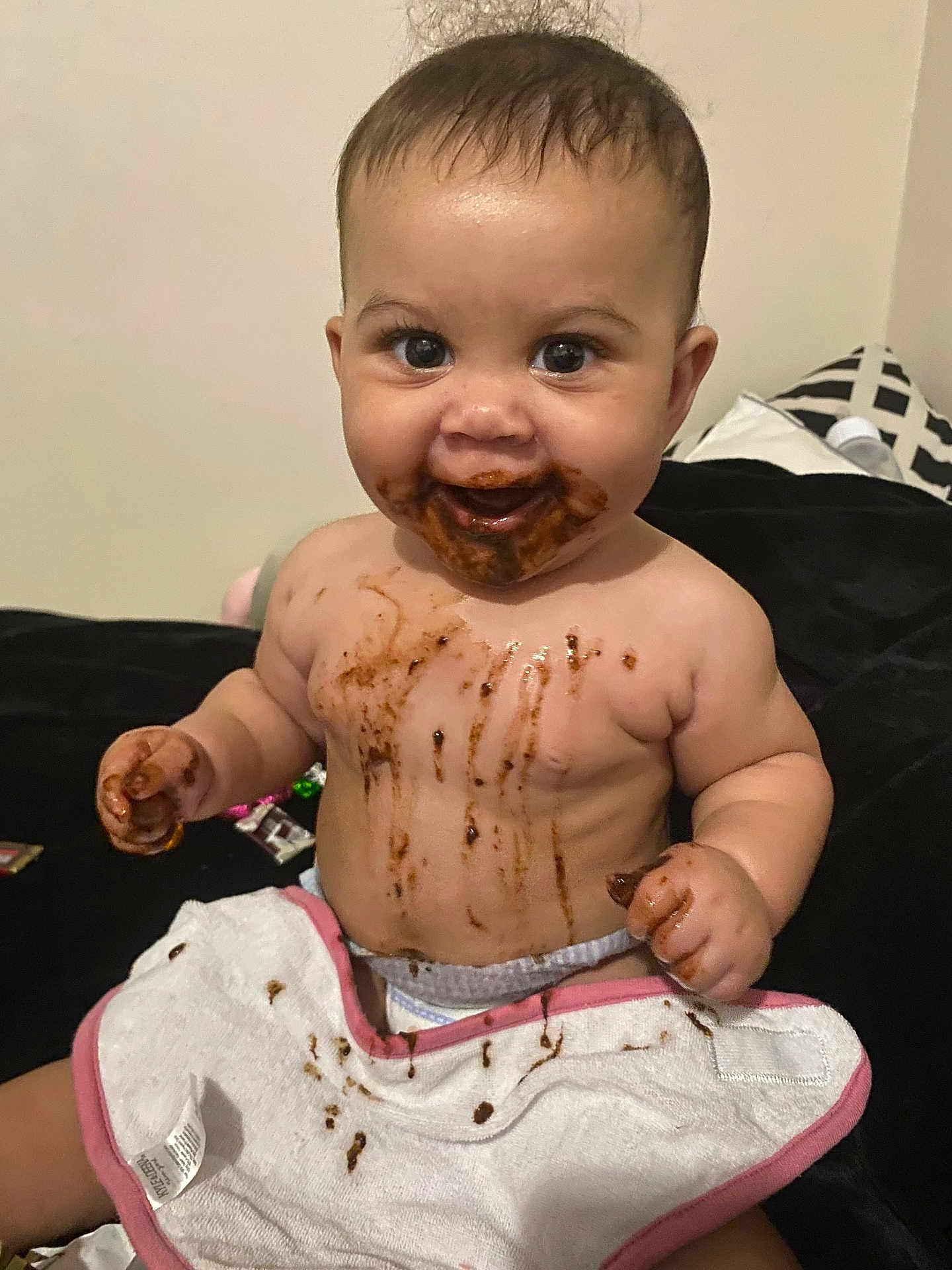 Kenleanna joined the competition — help win amazing prizes! baby, chocolate, messy, smiling, bib, infant, face, hands, diaper, skin, cute, happy, sitting, indoor, child, food, playful, mess, expression, small