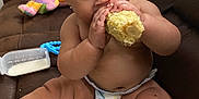Kenleanna is registered to the contest to win money with this photo: baby, diaper, corn, eating, couch, bottle, toy, napkin, milk, child, indoor, brown_couch, cute, messy, barefoot, chubby, infant, sitting, food, feeding