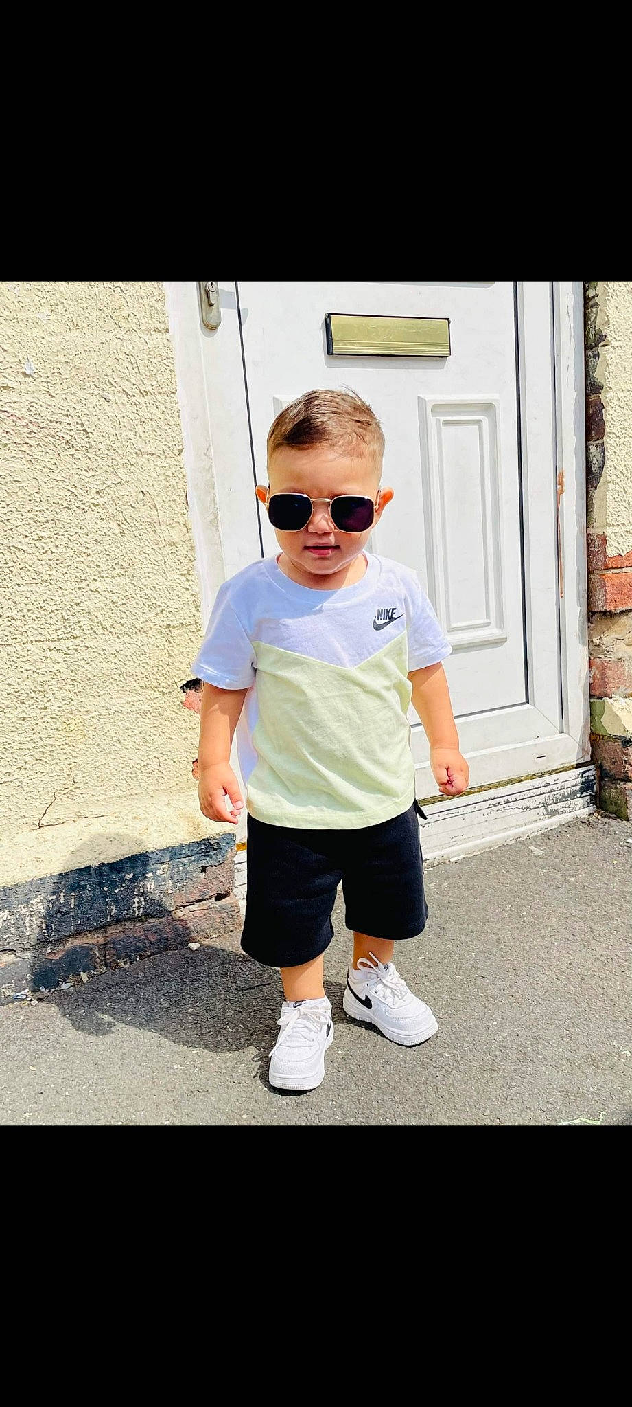Kristian joined the competition — help win amazing prizes! denim, door, electric_blue, eyewear, fashion_design, glasses, human_leg, knee, leisure, neck, person, recreation, shorts, sleeve, sportswear, standing, sunglasses, t_shirt, toddler, vision_care