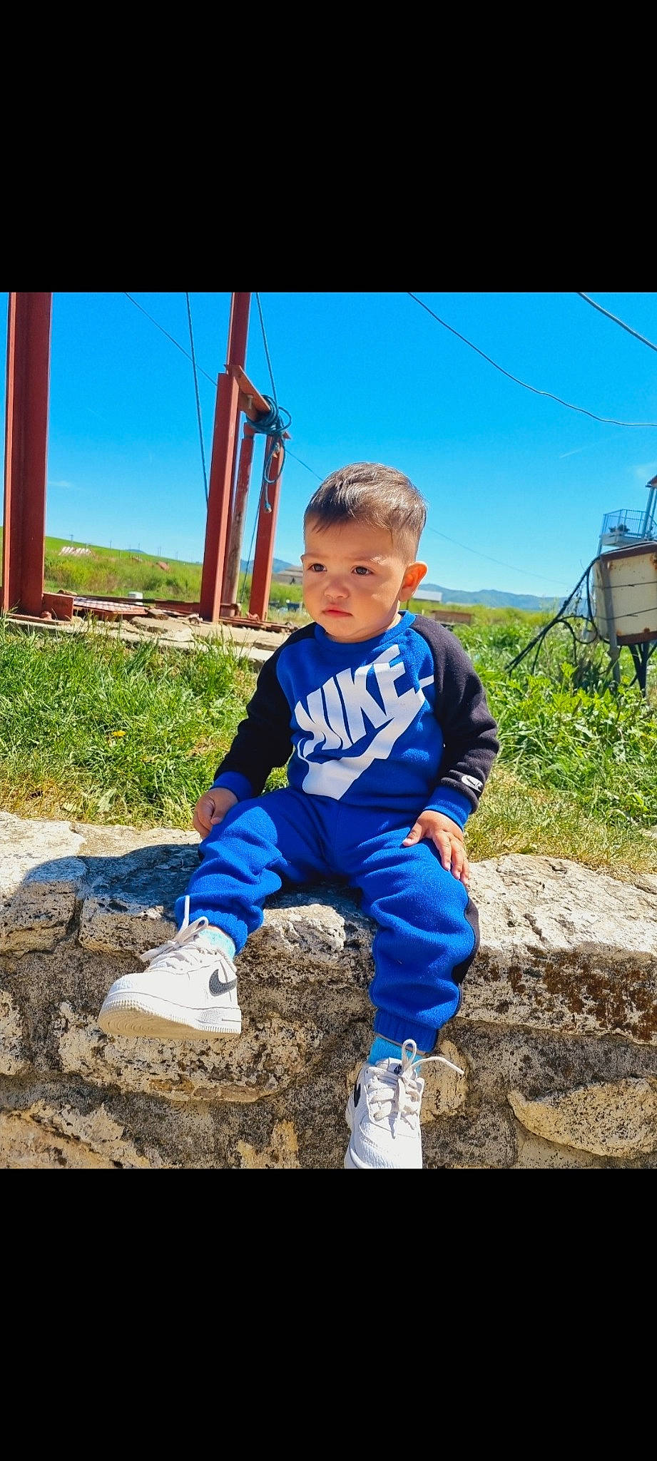 Kristian joined the competition — help win amazing prizes! child, electric_blue, flash_photography, fun, grass, grassland, happy, landscape, leisure, people_in_nature, person, rock, shoe, sitting, sky, sleeve, sneakers, soil, t_shirt, toddler
