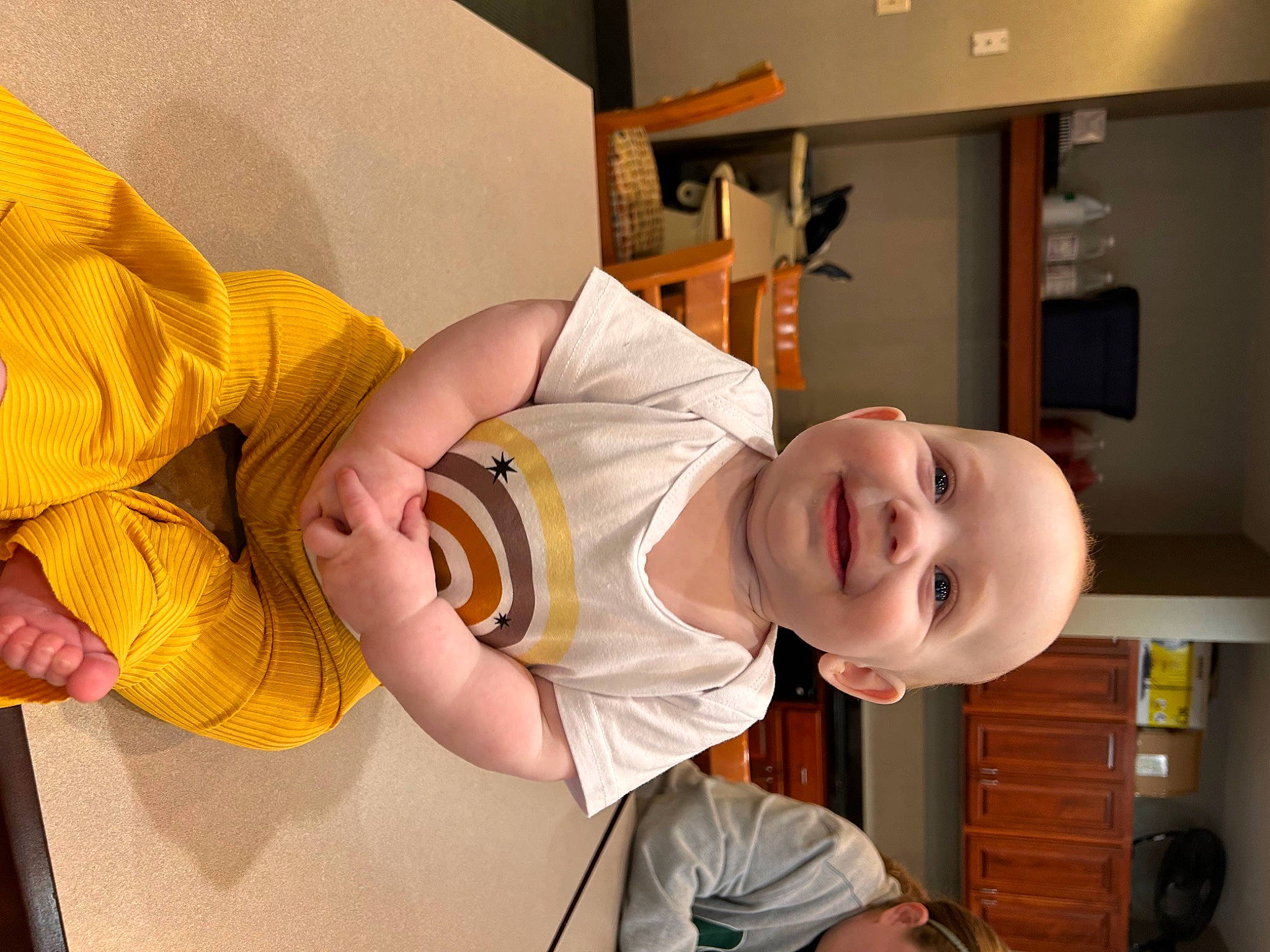 Cora is registered to the contest to win money with this photo: baby, baby_products, baby_safety, baby_toddler_clothing, chair, child, comfort, elbow, finger, fun, happy, hat, joy, kitchen, mouth, person, room, sleeve, smile, t_shirt