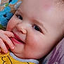 Reilly joined the competition — help win amazing prizes! baby, smile, face, child, yellow_clothing, hand, fingers, pillow, floral_pattern, closeup, skin, cheek, eyelashes, head, couch, comfort, cute, portrait, resting, indoors