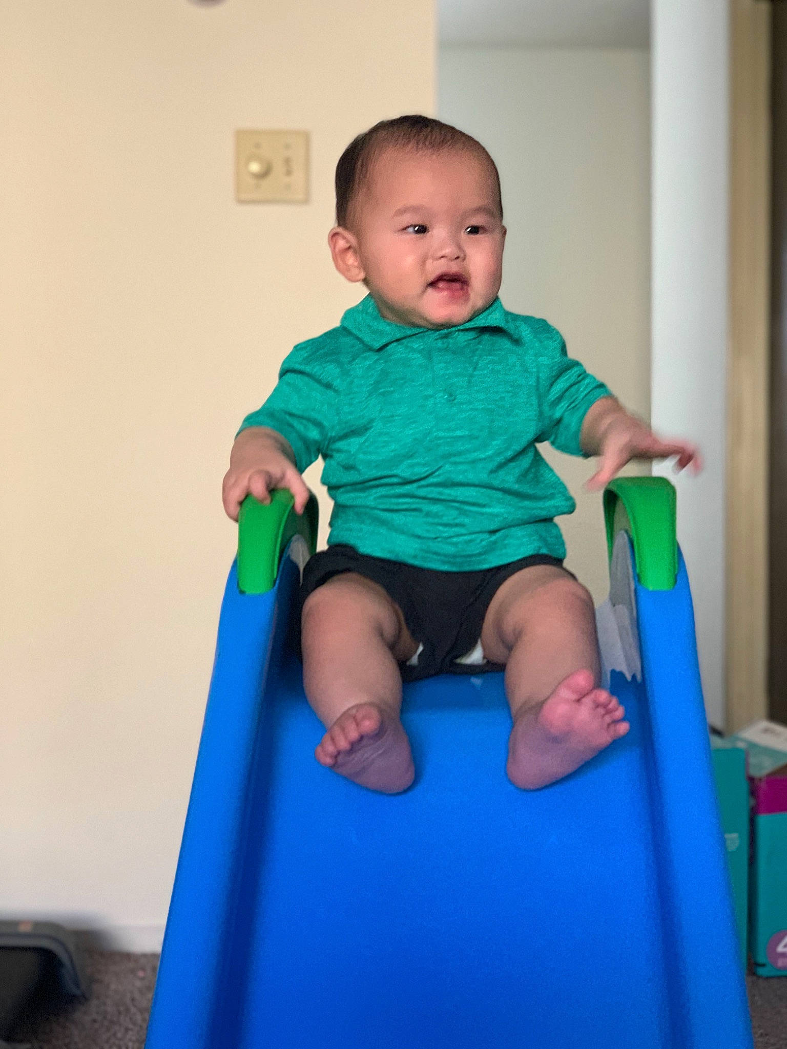 Russell Vang is registered to the contest to win money with this photo: aqua, baby, baby_toddler_clothing, blue, child, electric_blue, finger, human_body, knee, majorelle_blue, outdoor_play_equipment, person, plastic, play, playground, playground_slide, public_space, sitting, standing, teal