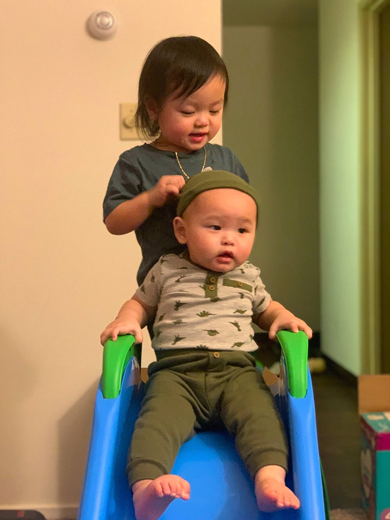 Russell Vang is registered to the contest to win money with this photo: baby, baby_toddler_clothing, box, carton, child, comfort, ear, eye, finger, human_body, joint, knee, lap, mouth, person, plastic, play, shipping_box, sitting, skin