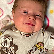 Paisley joined the competition — help win amazing prizes! baby, infant, newborn, portrait, close_up, smile, onesie, pacifier, blanket, cartoon_print, mickey_mouse, donald_duck, cheeks, hair, lying_down, soft_texture, cute, happy, indoors, baby_clothing