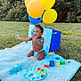 Jonathan is registered to the contest to win money with this photo: toddler, child, painting, paint, balloons, blanket, outdoor, grass, happy, smiling, art_supplies, palette, brush, colorful, nature, play, sunlight, expression, messy, diaper