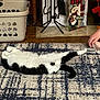 Silver Cherry joined the competition — help win amazing prizes! cat, black_and_white, lying_down, stretching, rug, patterned_rug, bare_feet, human, indoor, laundry_basket, holiday_decor, snowman_ornament, wood_floor, cozy, relaxed, pet, animal, furniture, home, playful