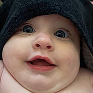 Hazel joined the competition — help win amazing prizes! baby, face, child, smile, eyes, hood, black_cloth, cute, portrait, infant, closeup, skin, chubby_cheeks, expression, happy, adorable, headwear, indoors, person, young_child