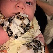 Everett is registered to the contest to win money with this photo: baby, infant, close_up, face, eyes, yellow_clothing, socks, smiley_faces, hand, person, cute, child, soft_light, indoor, portrait, young, skin, expression, holding, fabric