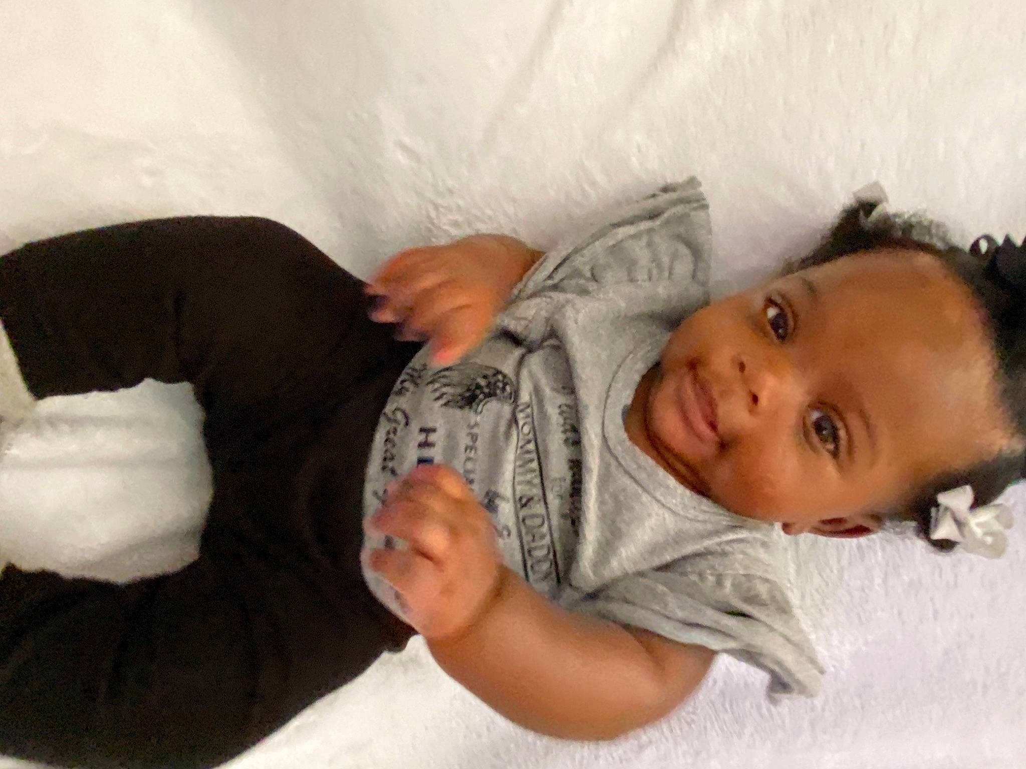Chariah joined the competition — help win amazing prizes! arm, baby, baby_toddler_clothing, cheek, child, chin, comfort, elbow, eye, eyelash, gesture, hand, linens, nose, person, room, sitting, skin, sleeve, smile
