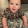 baby, camouflage_shirt, carpet, child, crawling, curious, cute, drool, eyes, face, floor, furniture, hands, home, indoor, living_room, person, plush, toddler, wood_floor
