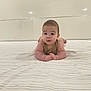 Liam joined the competition — help win amazing prizes! baby, infant, bed, bedroom, sheet, striped_sheet, face, child, person, curious, arms, head, skin, sleepwear, indoor, soft_lighting, blanket, pale_colors, furniture, resting