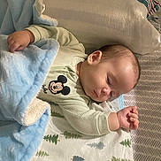 Liam joined the competition — help win amazing prizes! baby, sleeping, blanket, mickey_mouse, clothing, bed, pillow, infant, peaceful, cute, pattern, soft, resting, child, portrait, indoors, comfort, toddler, sleep, cozy