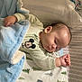 baby, sleeping, blanket, mickey_mouse, clothing, bed, pillow, infant, peaceful, cute, pattern, soft, resting, child, portrait, indoors, comfort, toddler, sleep, cozy